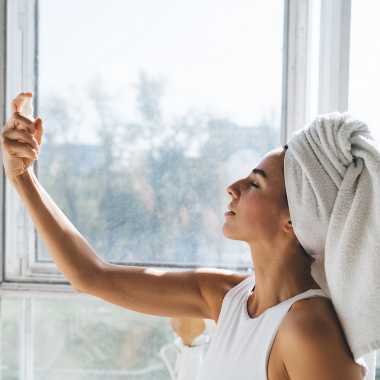 woman using at-home skincare | face mist