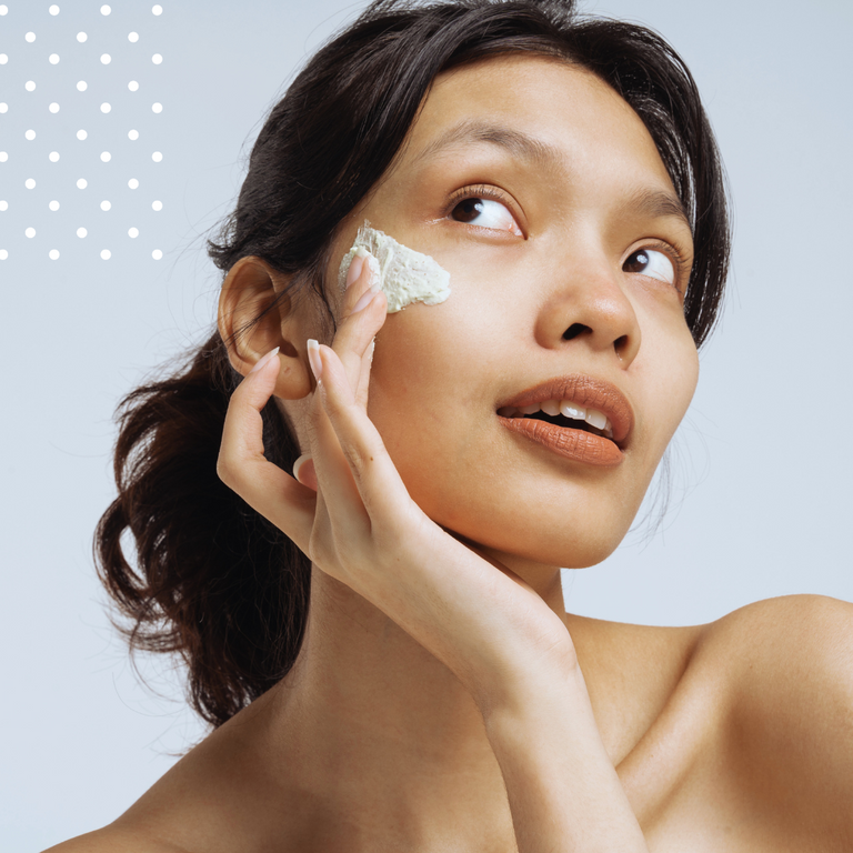 woman close-up with skincare product under eyes
