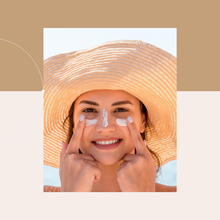 Woman in Hat with Sunscreen on Cheeks 