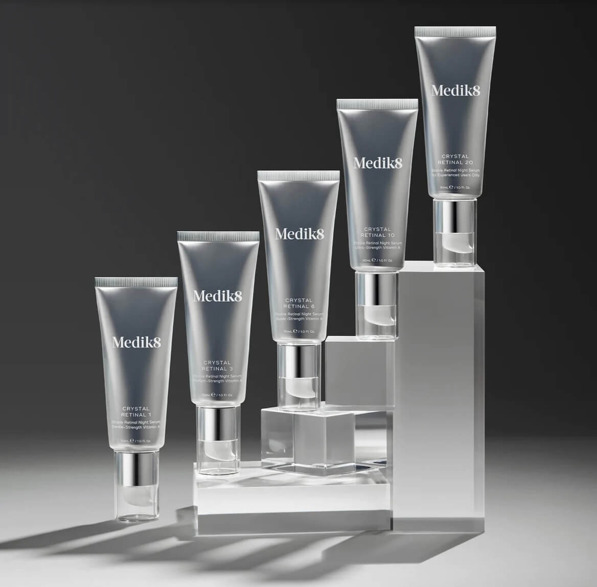 Set of Medik8 skincare products on a gray background