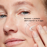 Close-up of a person applying cream to their face with text indicating skin care benefits.