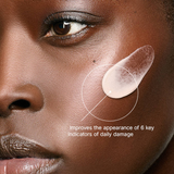 Close-up of a person's face with a skincare product application, highlighting daily damage indicators.