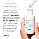 SkinCeuticals Discoloration Defense Serum bottle held by a hand with customer review text.